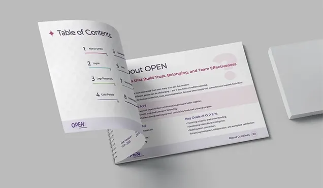 Open brand book with visual identity guidelines and brand content.