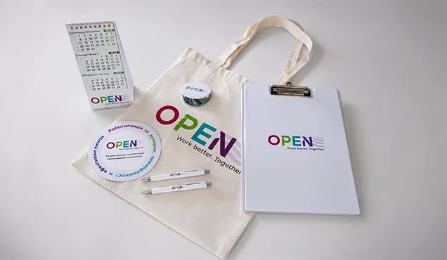 Фирмени материали за OPEN с брандирана торба, календар, клипборд, химикал и значки.